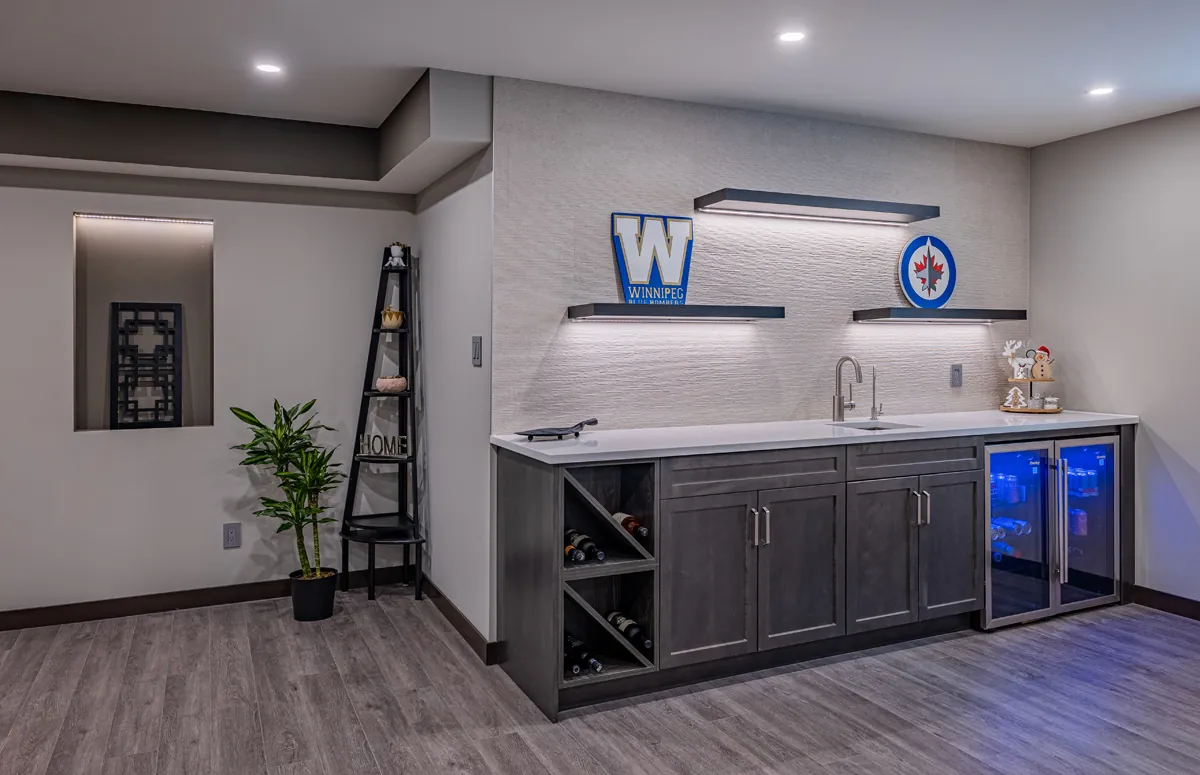 Wet bar with beverage fridges, wine rack and lit shelving