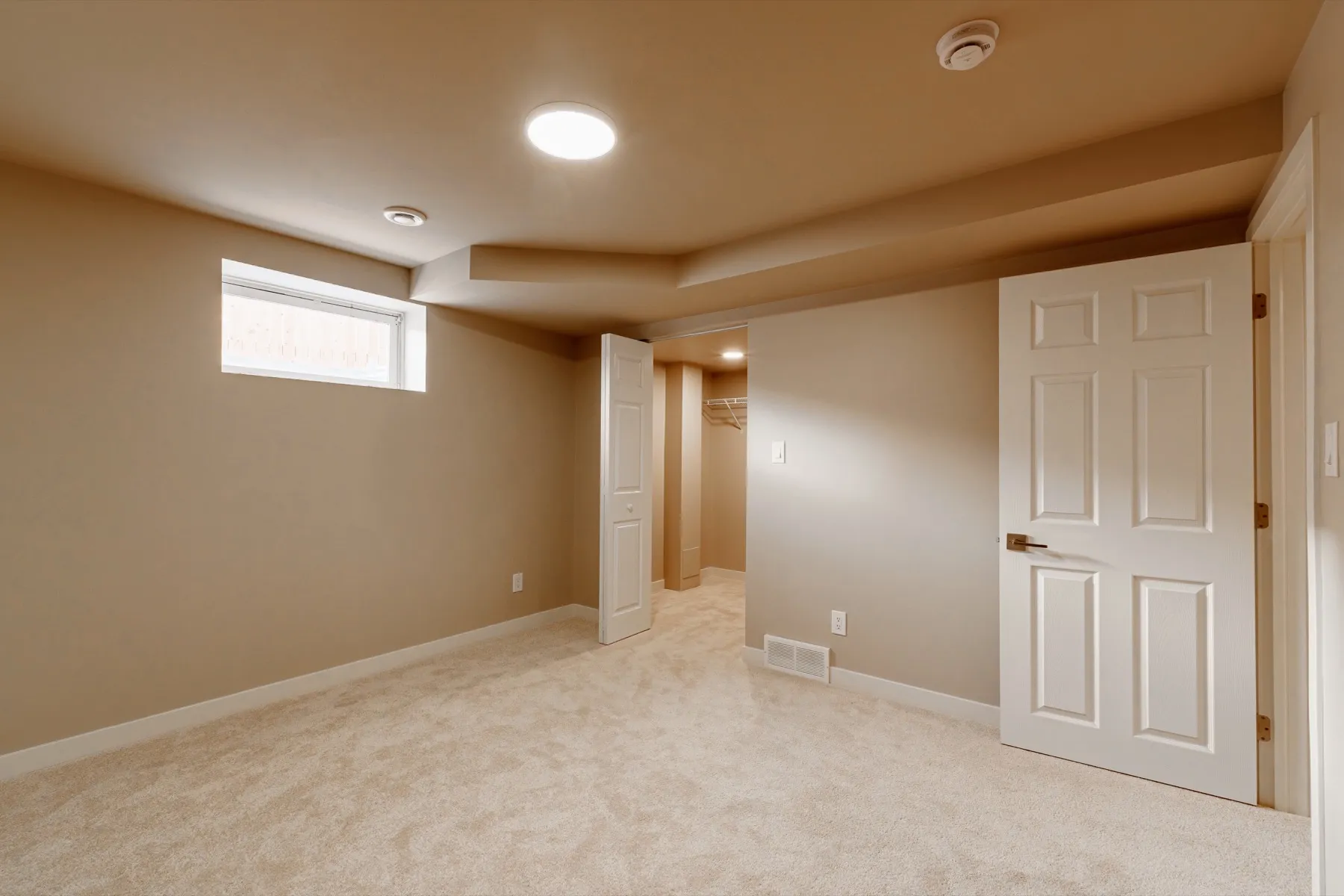 The basement bedroom, with a walk-in closet off the far corner