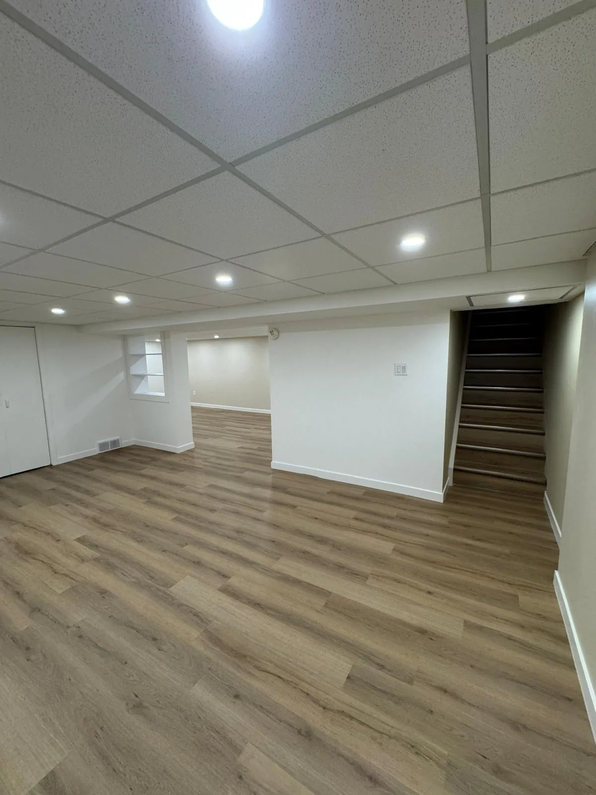 Looking across the lower level to the stair opening