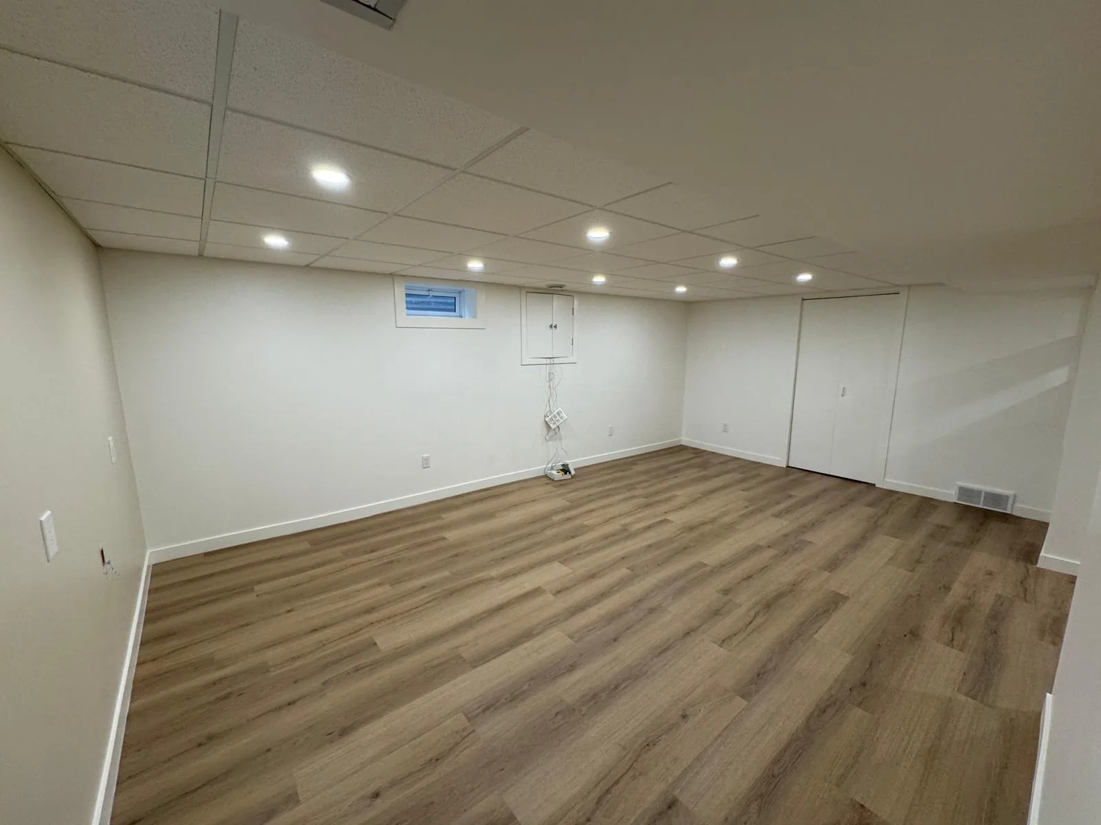 The finished floor from the doorway, plank laid the length of the room