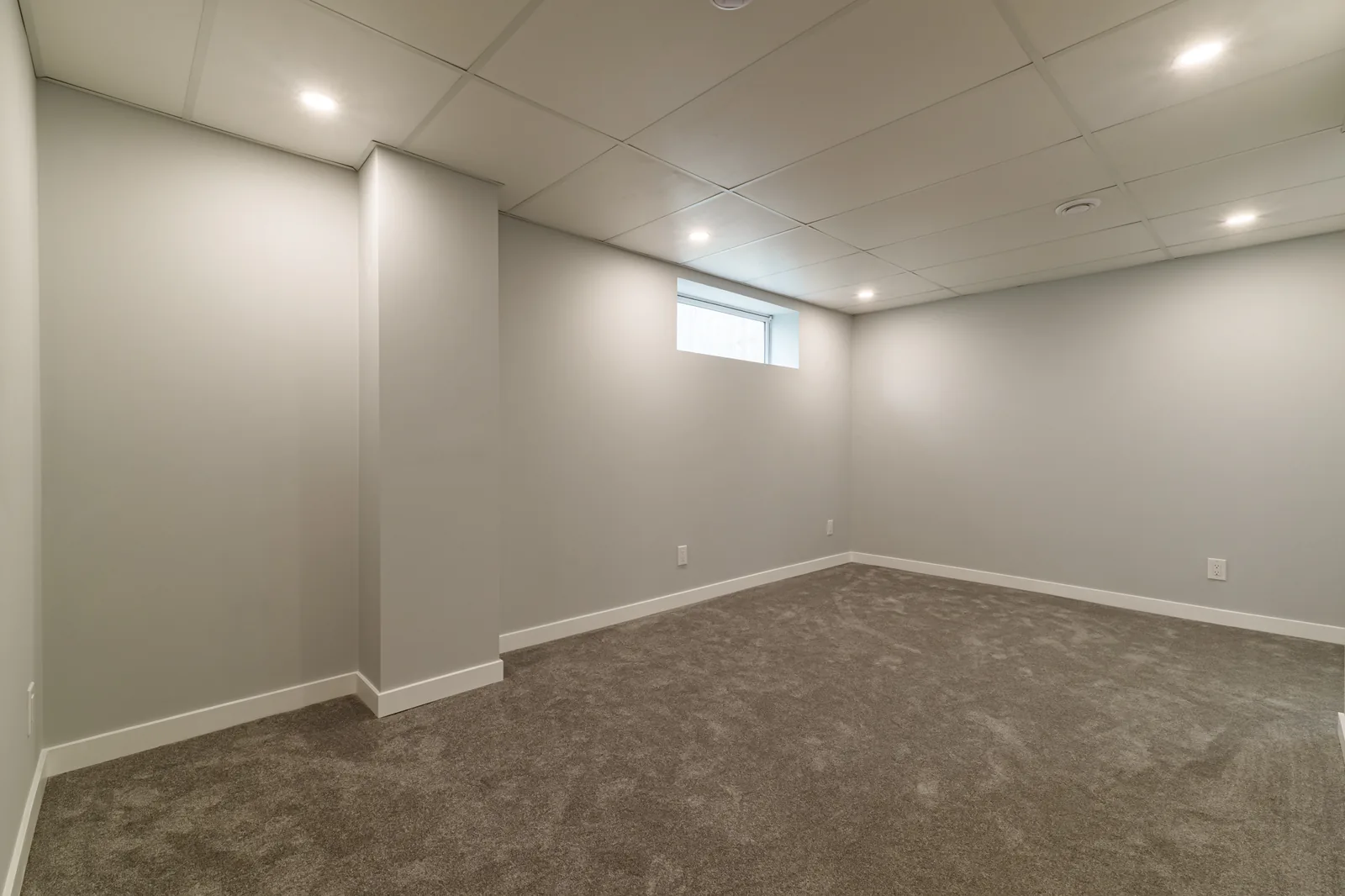 The lower level from the corner, window set high in the wall