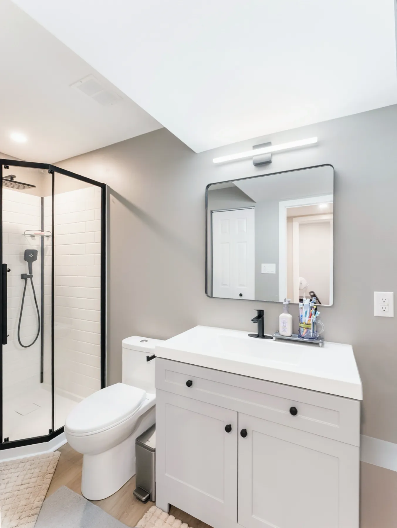 The bathroom from the door, shower and vanity in one view
