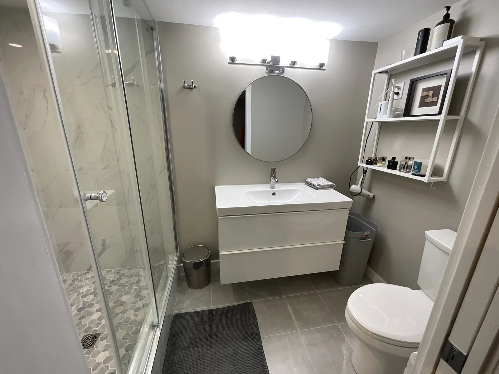 The shower and the vanity in one view, glass door drawn back