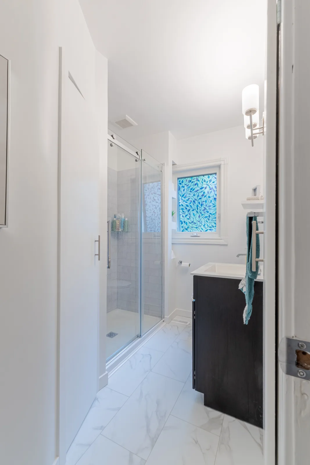 The bathroom seen from the hall through its open door