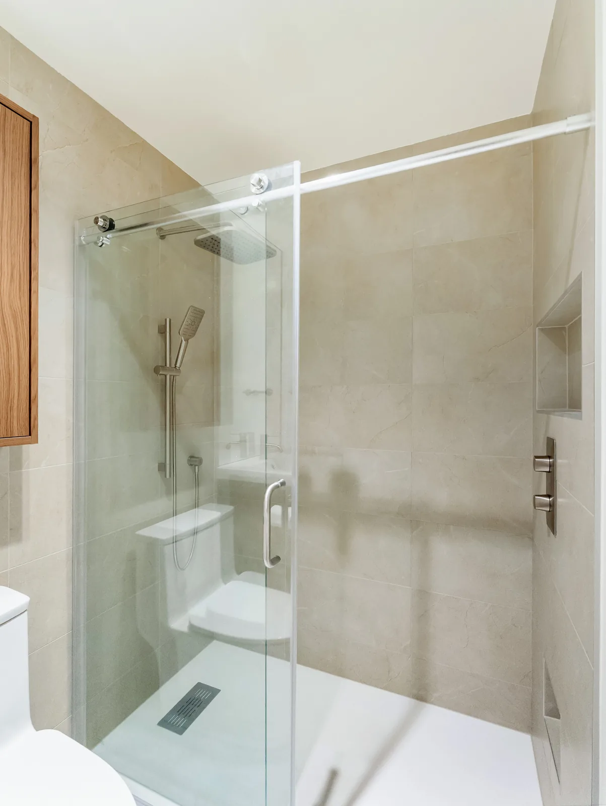 Inside the shower — recessed niche, linear drain and a low curbless base