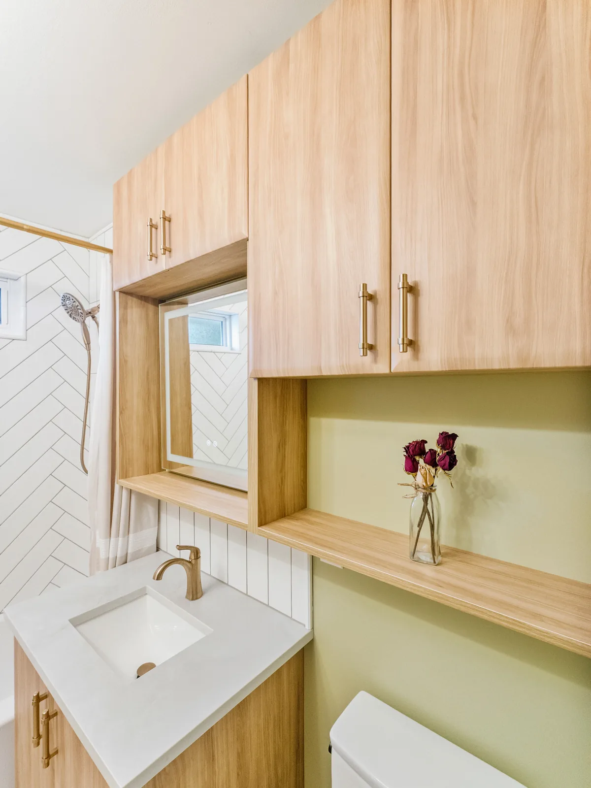 The finished bathroom end to end, oak and sage against white tile