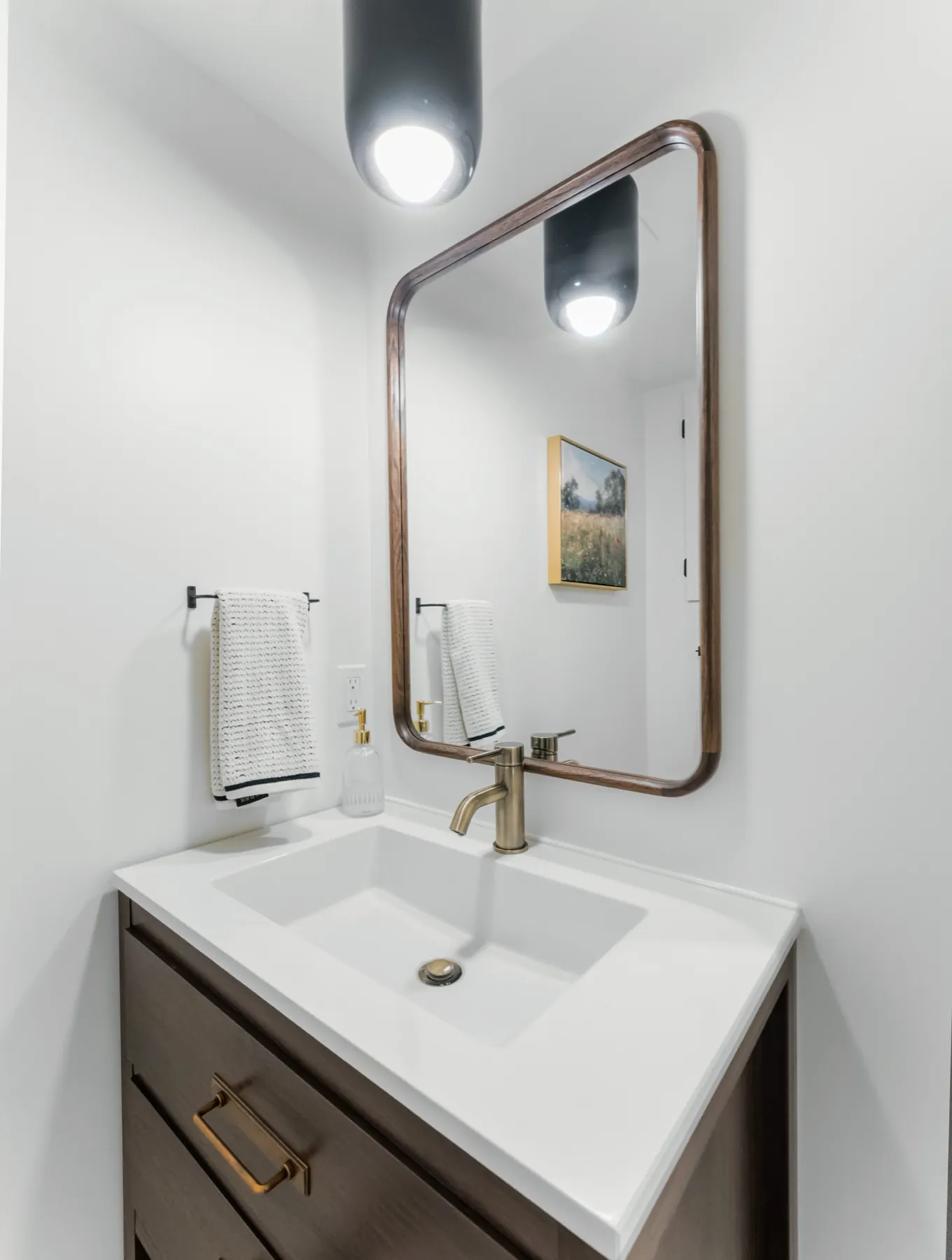 Basin, tap and mirror under the roof slope