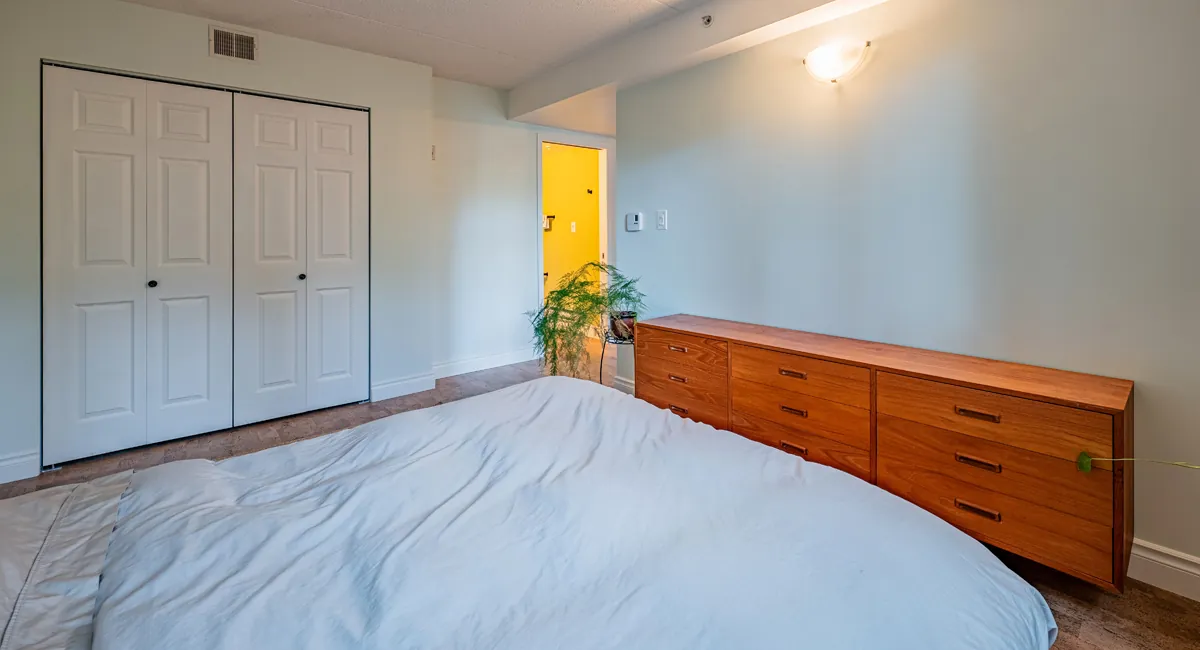 The bedroom's double closet beside the dresser