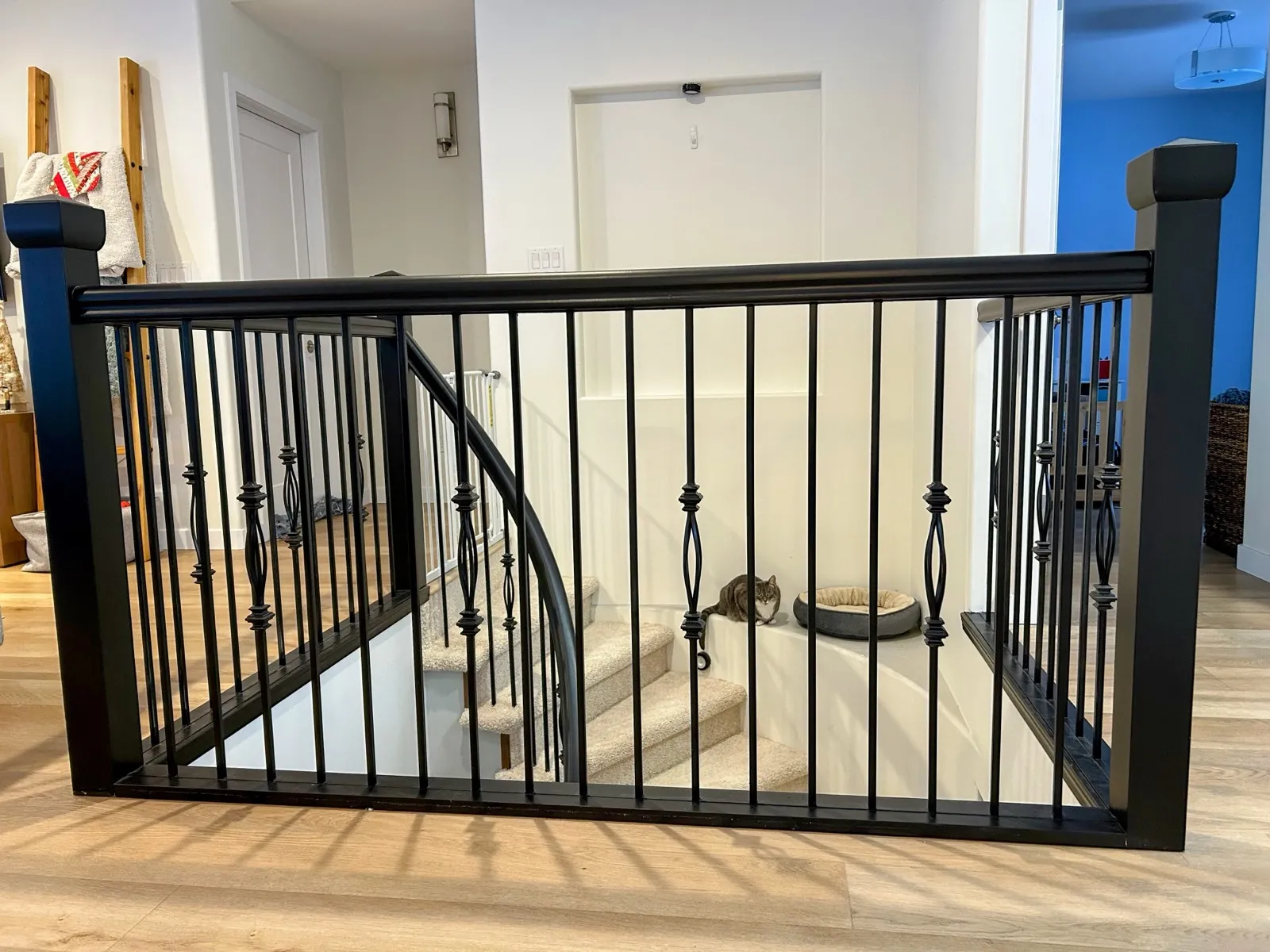 The new stair railing, black spindles with knuckle details, the handrail curving down with the stair