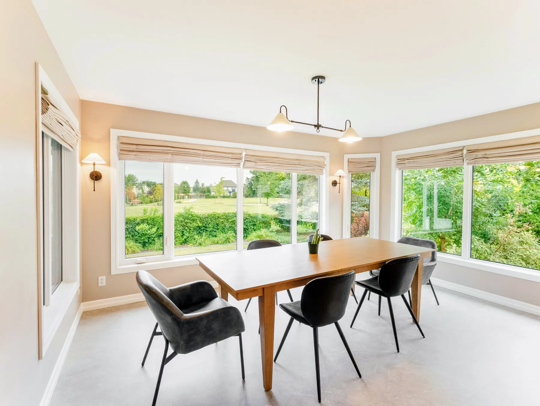 Dining table set into a bay of windows looking onto the garden