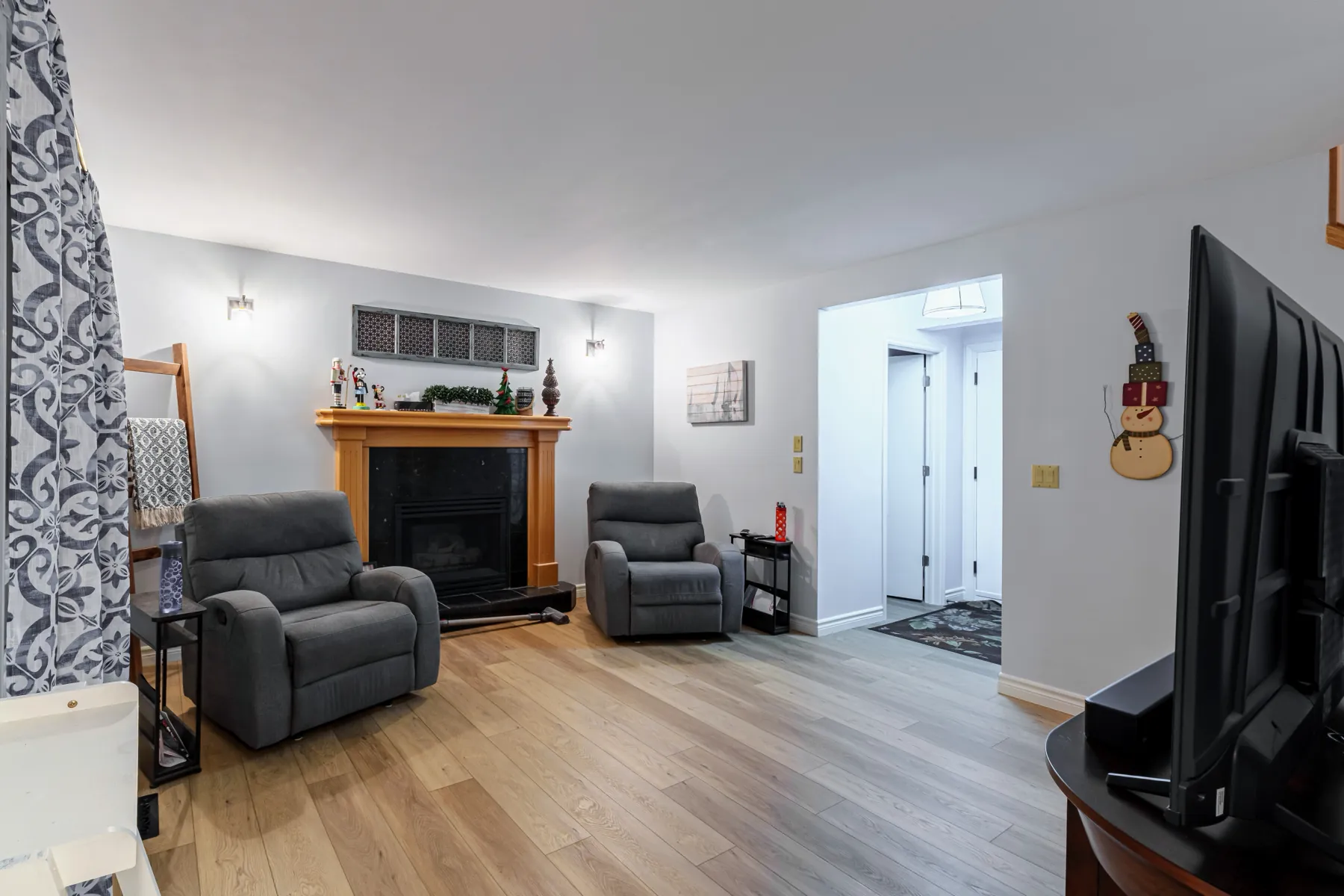 Living room with a fireplace, open through to the hall