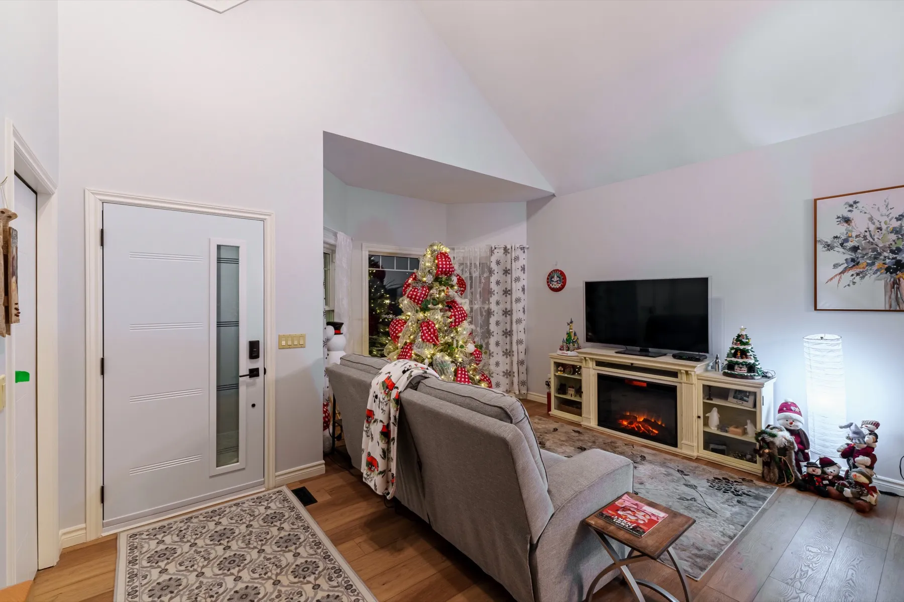 The living room inside the front door, plank flooring running through