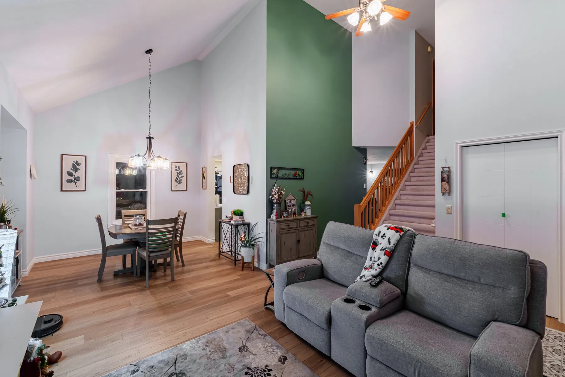 Living and dining under the vault, a green accent wall at the stair