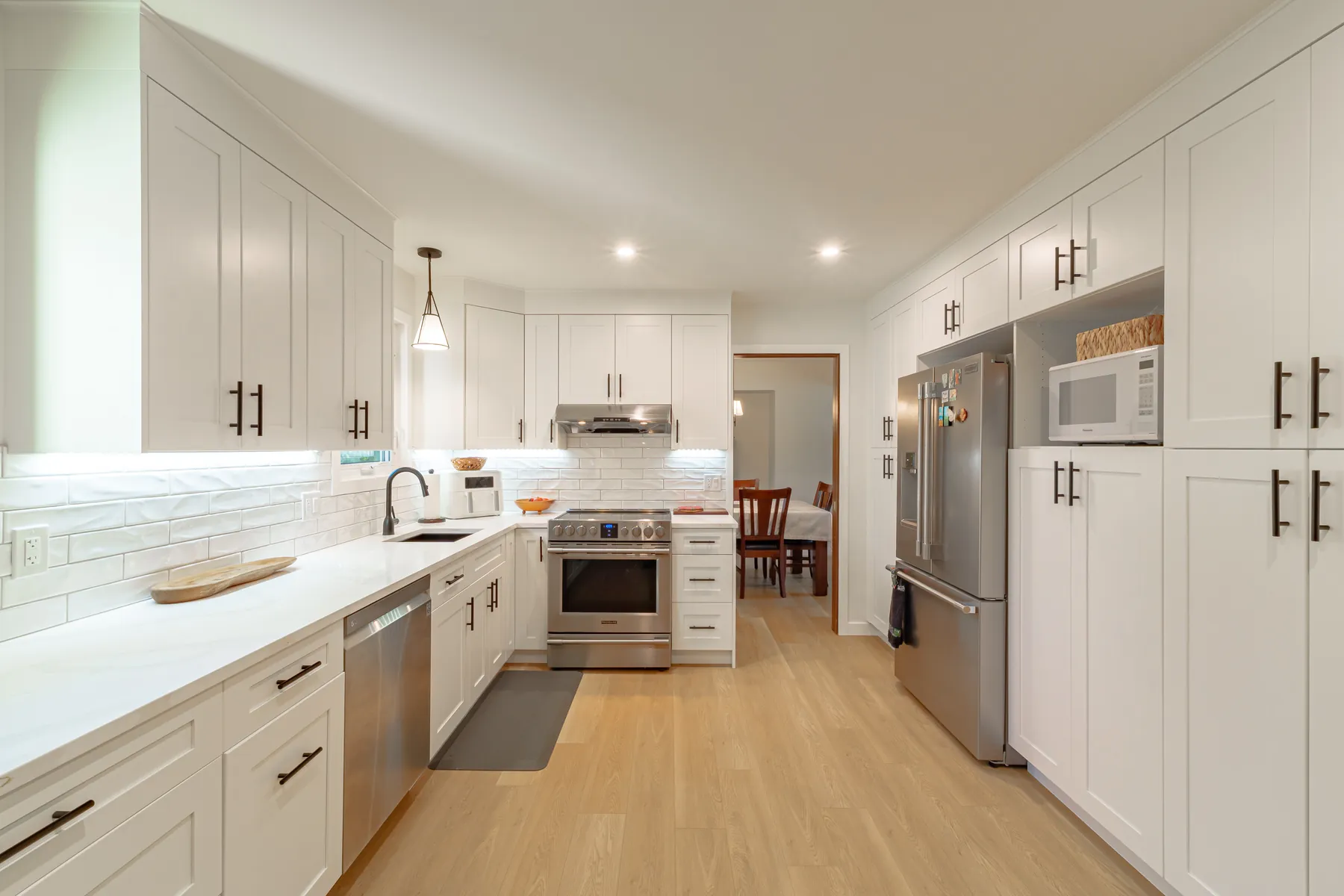 White shaker cabinetry and the counter run under the window