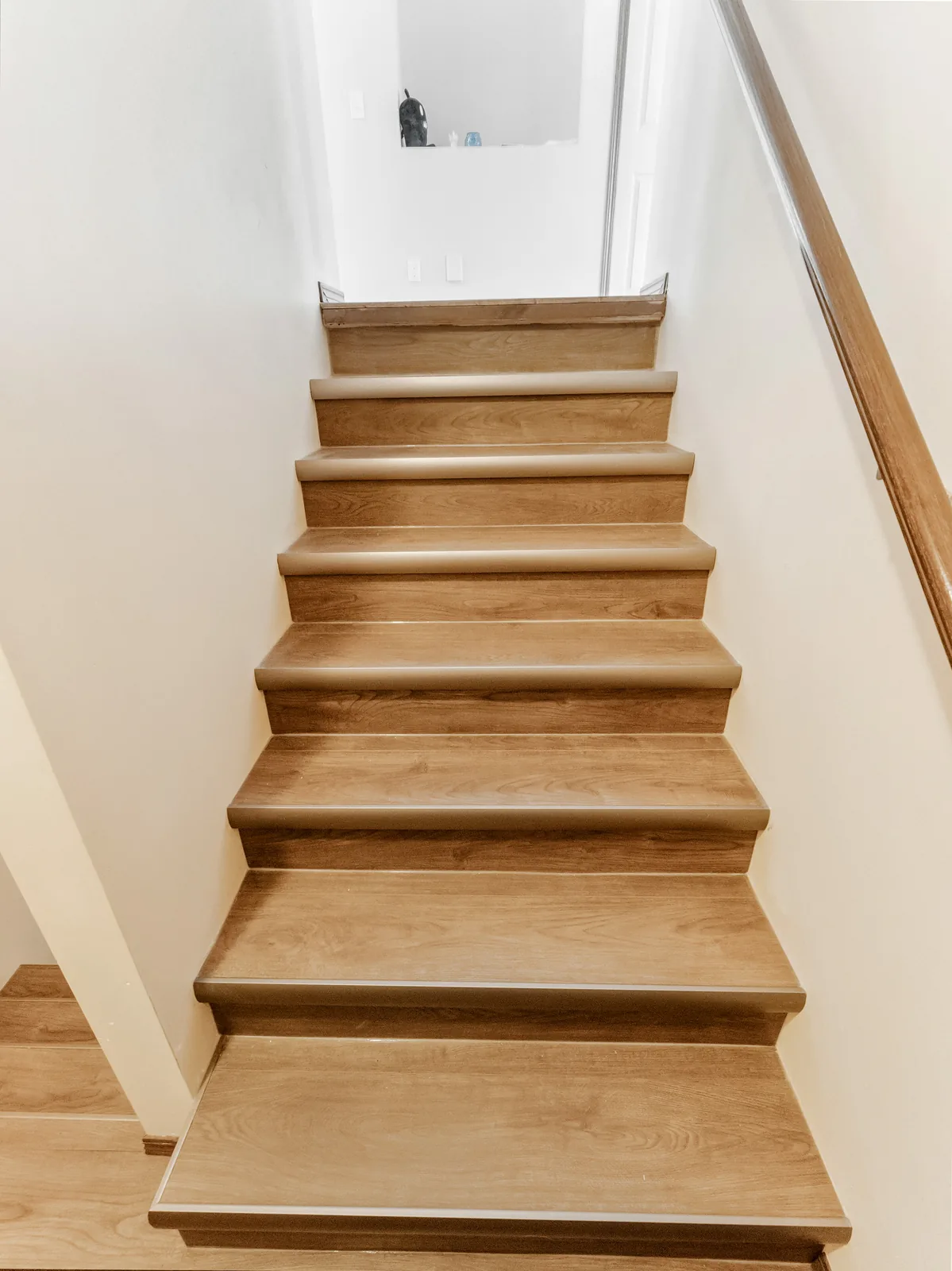 Rebuilt stair with wood treads running up to the main floor