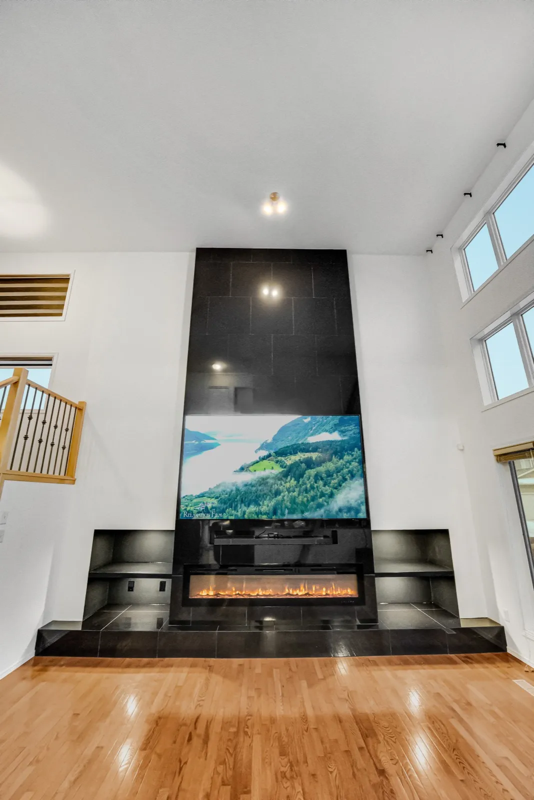 The wall straight on from the floor, hardwood running up to the hearth