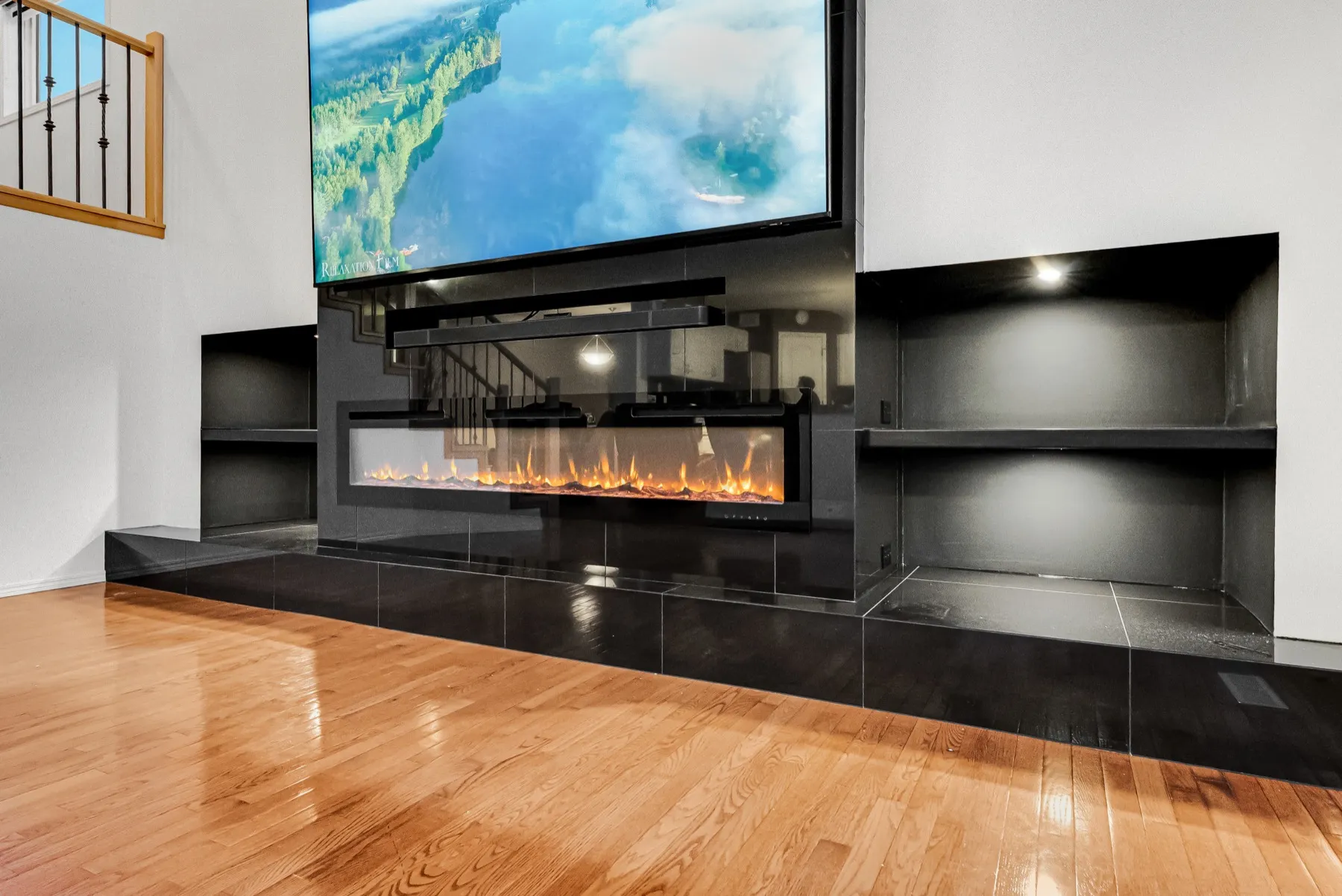 Linear fireplace and soundbar shelf, with lit open shelving built in either side