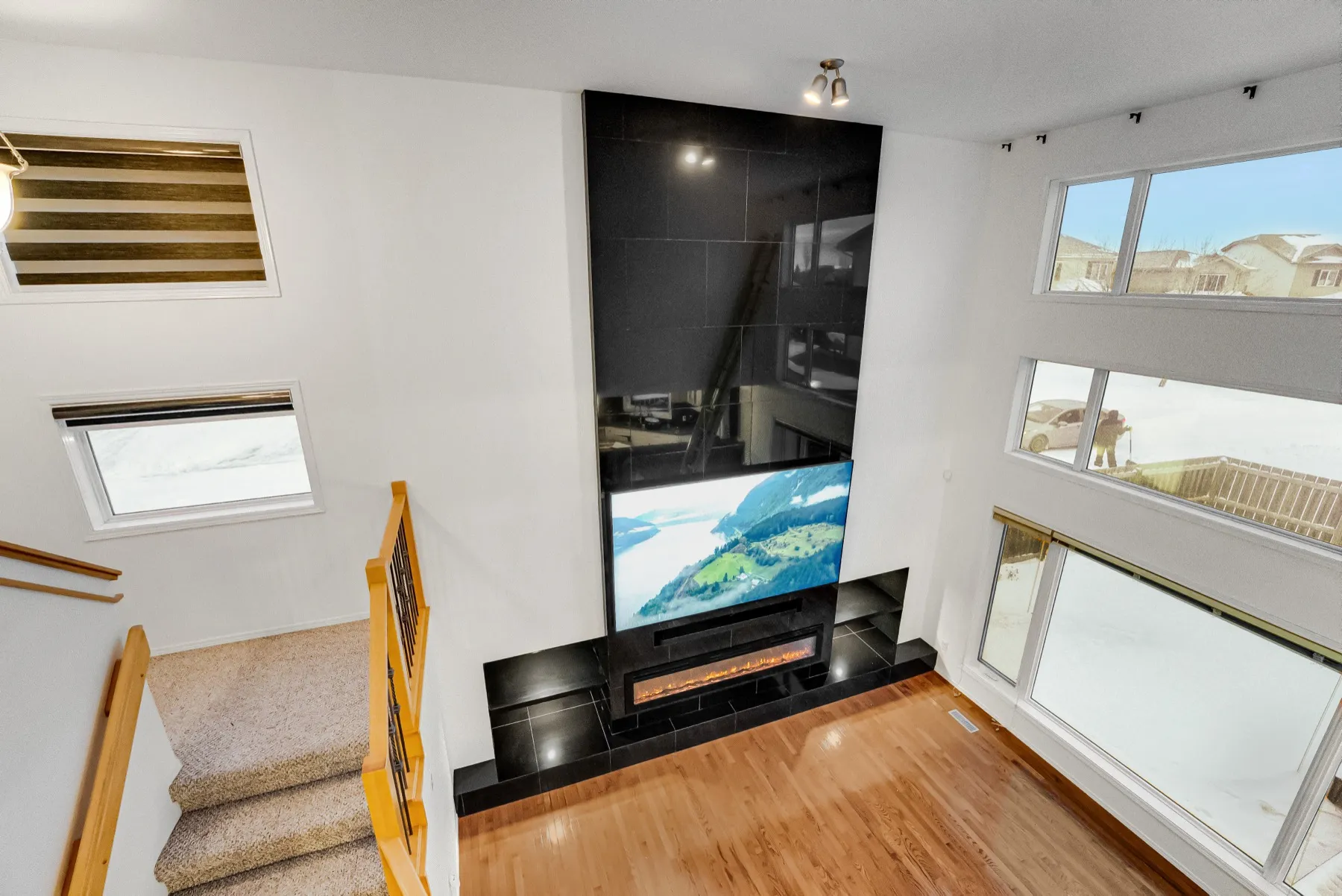 The great room from the upstairs landing, looking down on the wall and the raised hearth