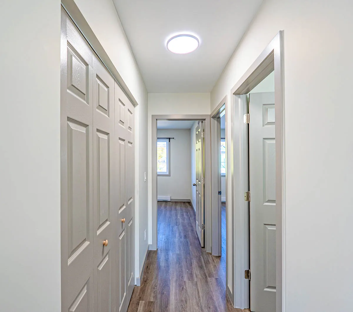 The hall, closet doors along one side