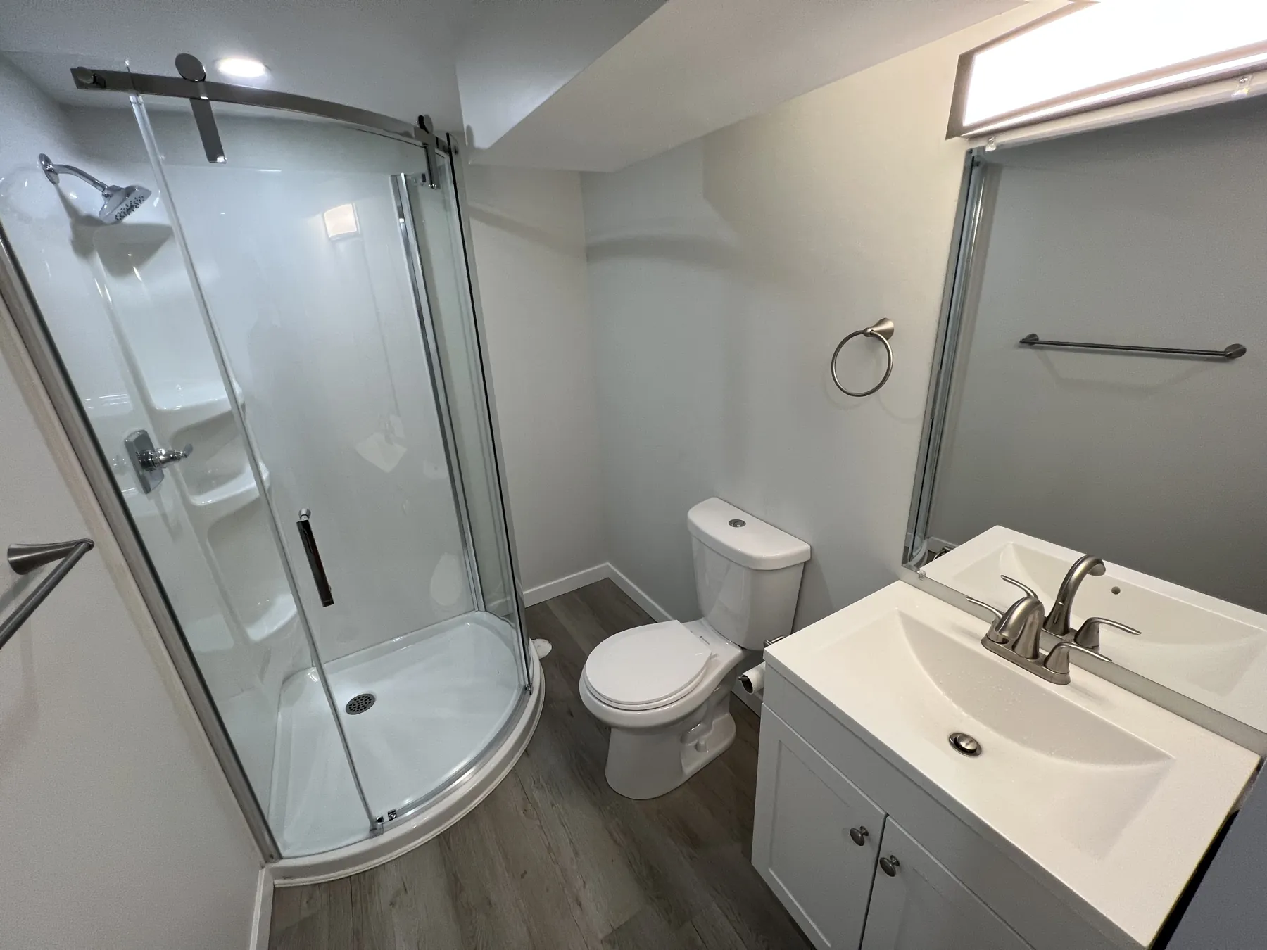 The suite bathroom, corner shower and vanity
