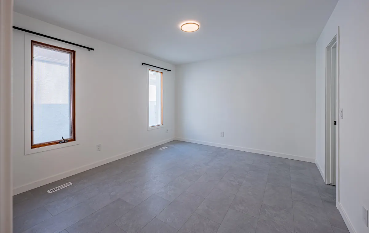 Corner bedroom with a window on each wall