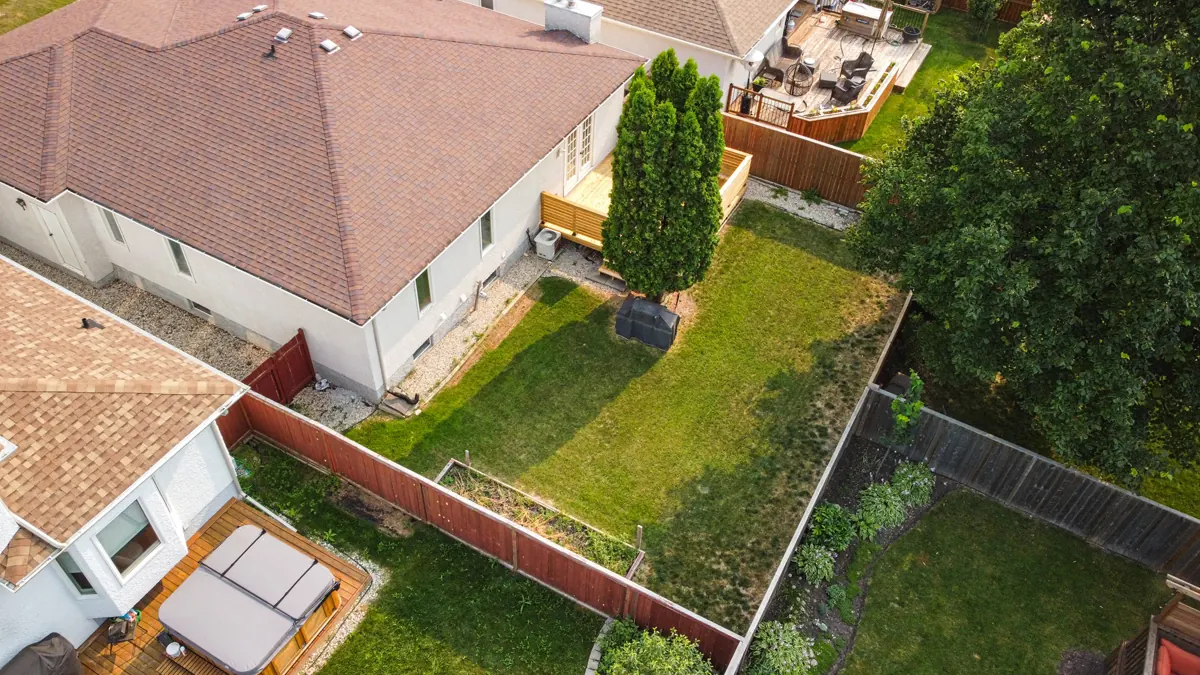 Aerial view over the roof to the back yard and its fence line