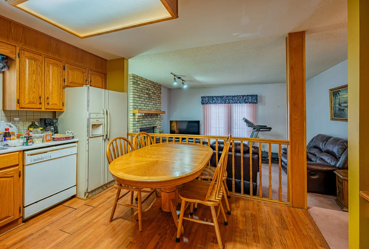 Before: the kitchen and eating area, the family room beyond the rail