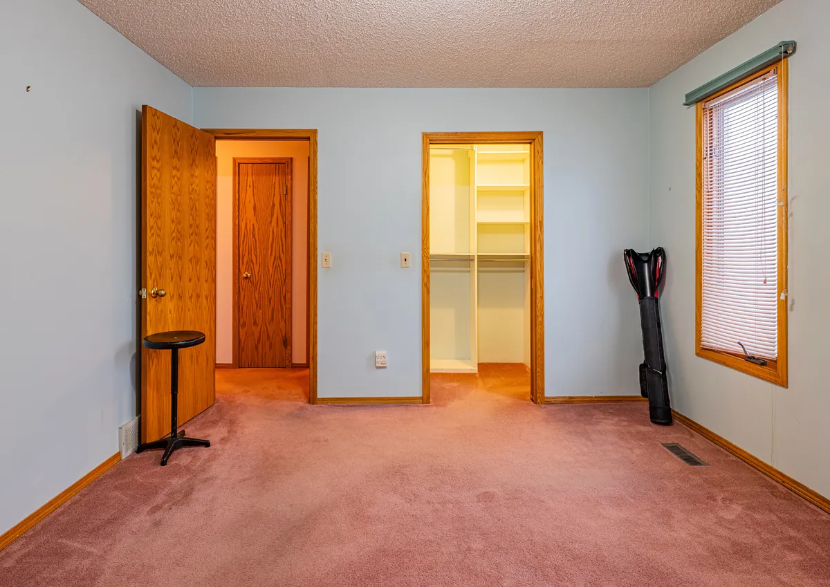 Before: a bedroom looking through to the walk-in closet