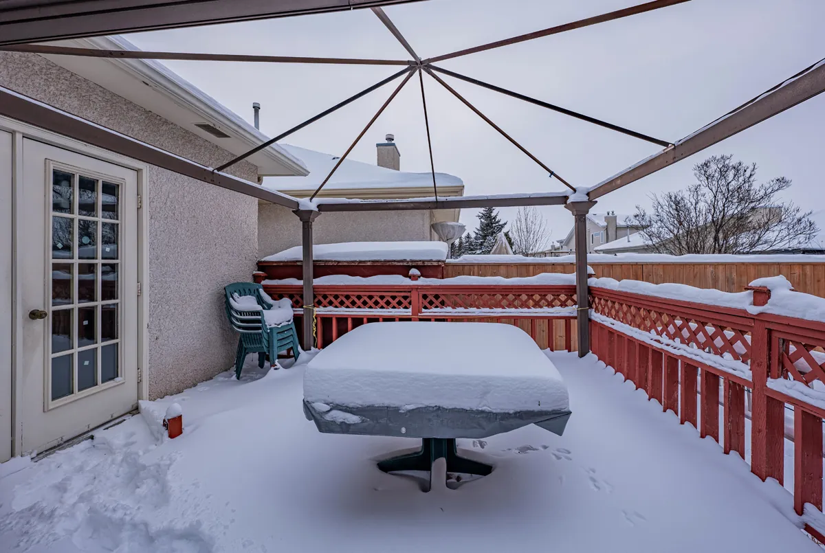 Before: the old deck in winter, under a pergola frame