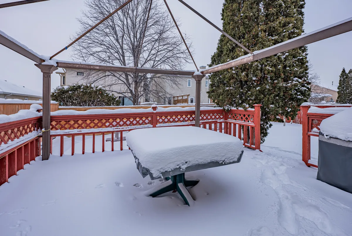 Before: the old deck and its lattice railing, snowed over