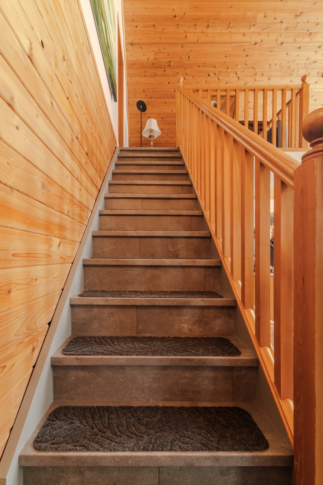 Stair to the loft, treads set against the cedar wall