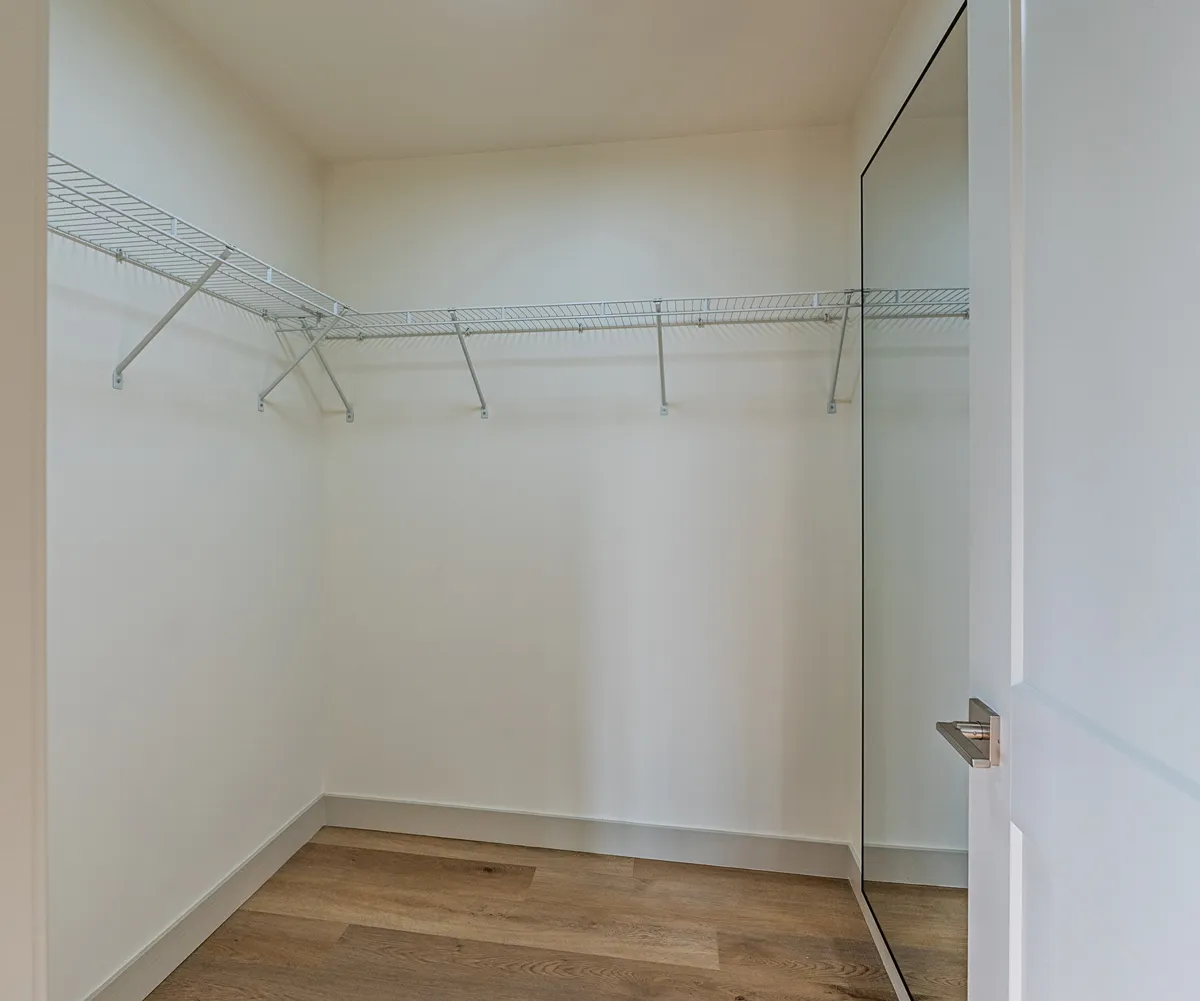 Walk-in closet fitted with hanging rails and shelving