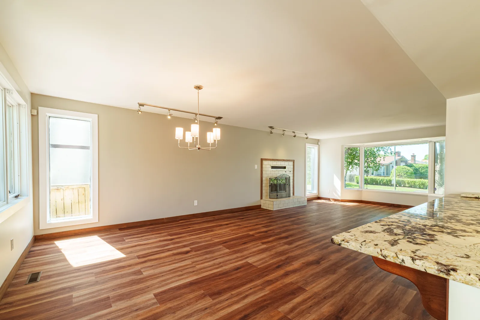Windows along the main floor, fresh paint and new flooring throughout