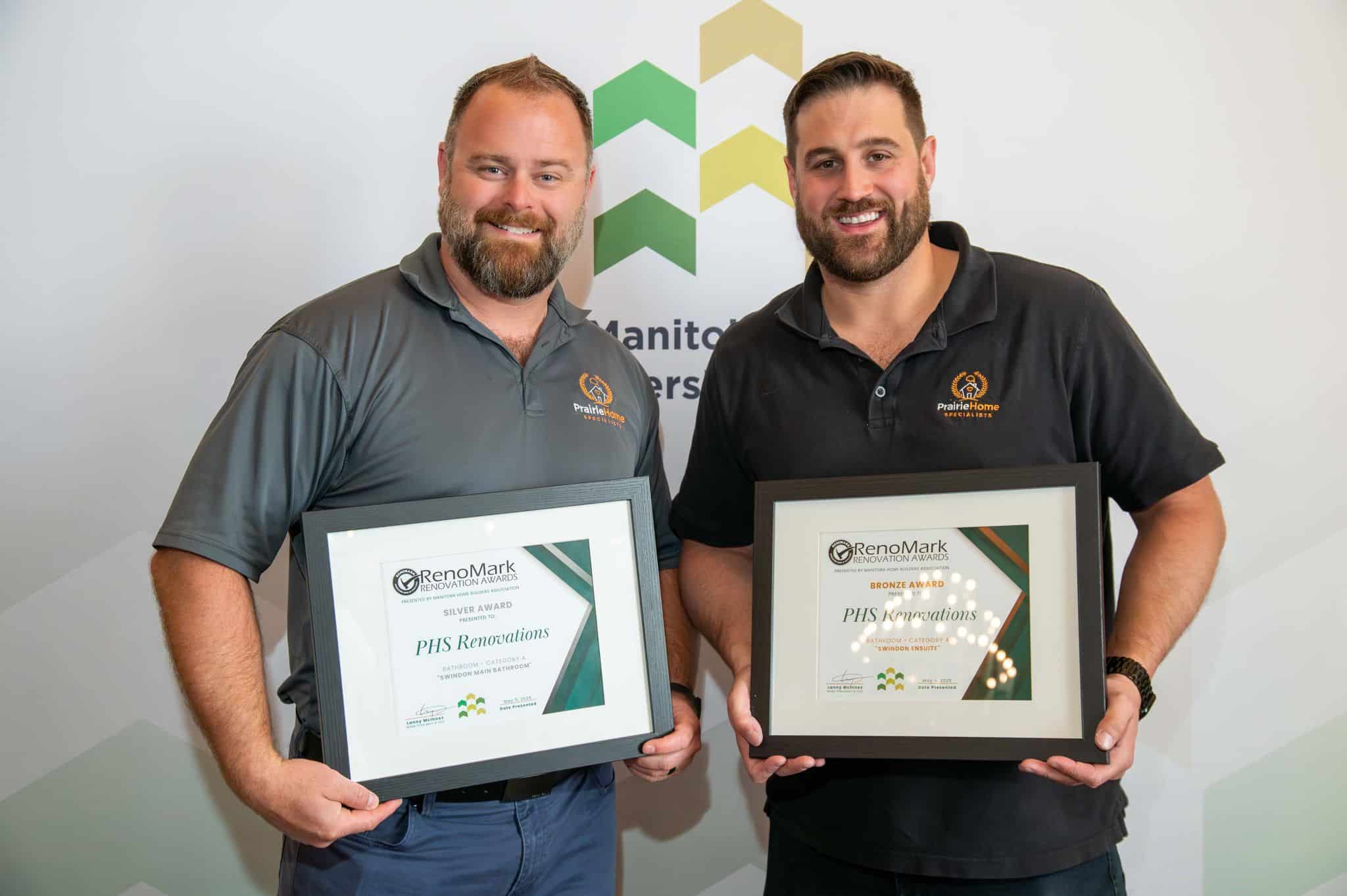 Mark and Chase holding PHS Renovations' RenoMark Renovation Awards: Silver and Bronze